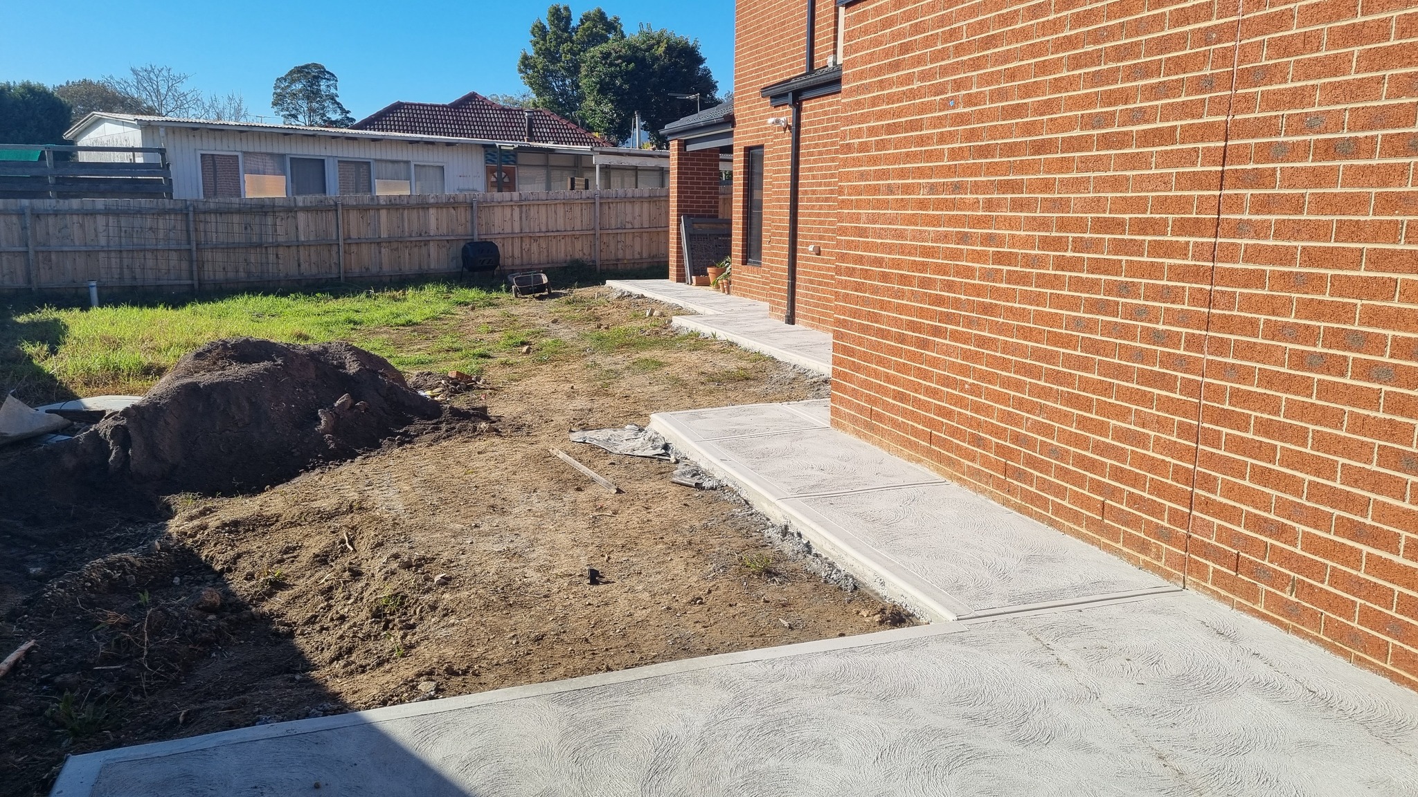 Completed concrete paths and landscaping at a Narre Warren home by Wade Concreting